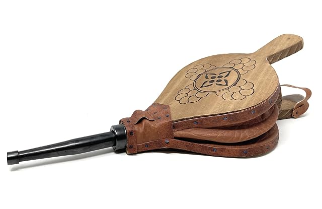 A handmade natural wood fireplace bellows 43 centimetres long with a wide air inlet