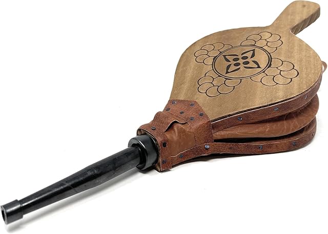 A handmade natural wood fireplace bellows 43 centimetres long with a 15 centimetre opening
