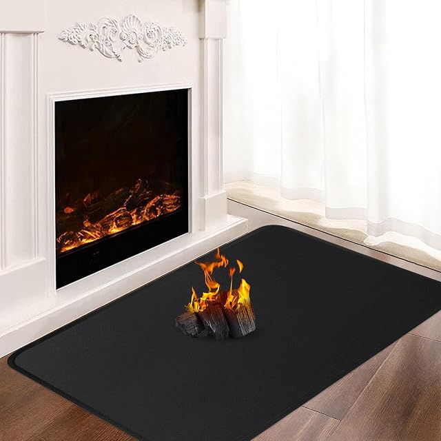 A thin black fire-resistant stove mat of silicone-coated glass fibre, one metre by sixty centimetres
